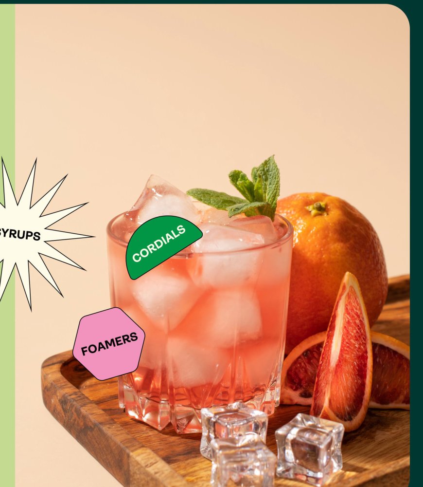 A beautifully crafted cocktail on a wooden board with fresh grapefruit